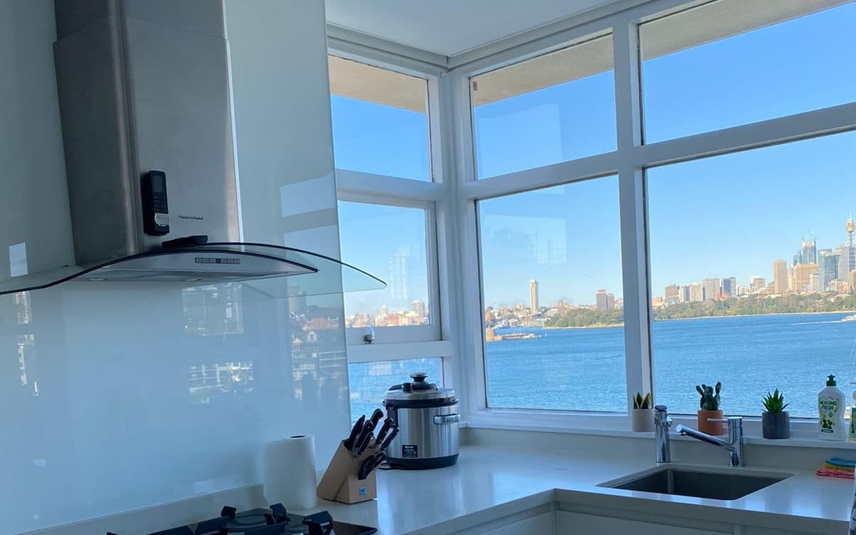 Clean stainless steel rangehood above a gas cooktop in a Sydney kitchen