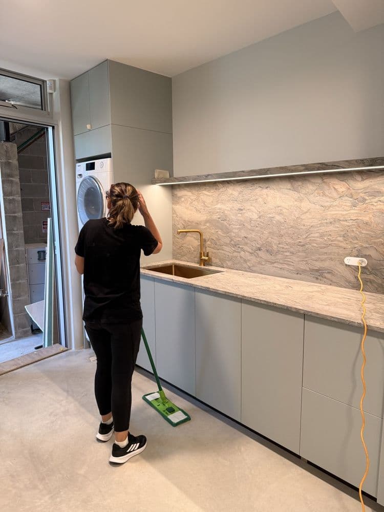Focus cleaner mopping a kitchen floor