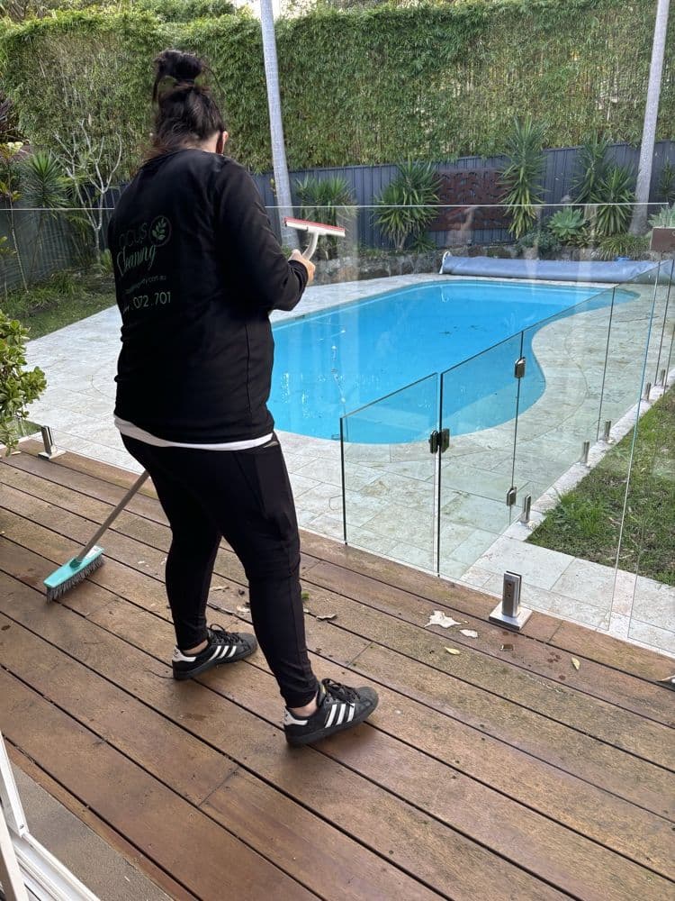 Focus cleaner sweeping a pool deck