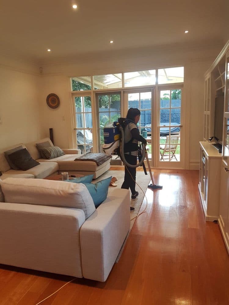 Focus cleaner vacuuming a living room