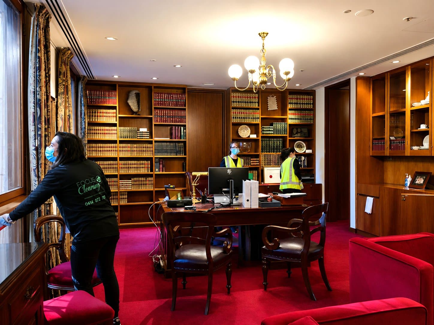 Focus cleaner working in a boardroom library