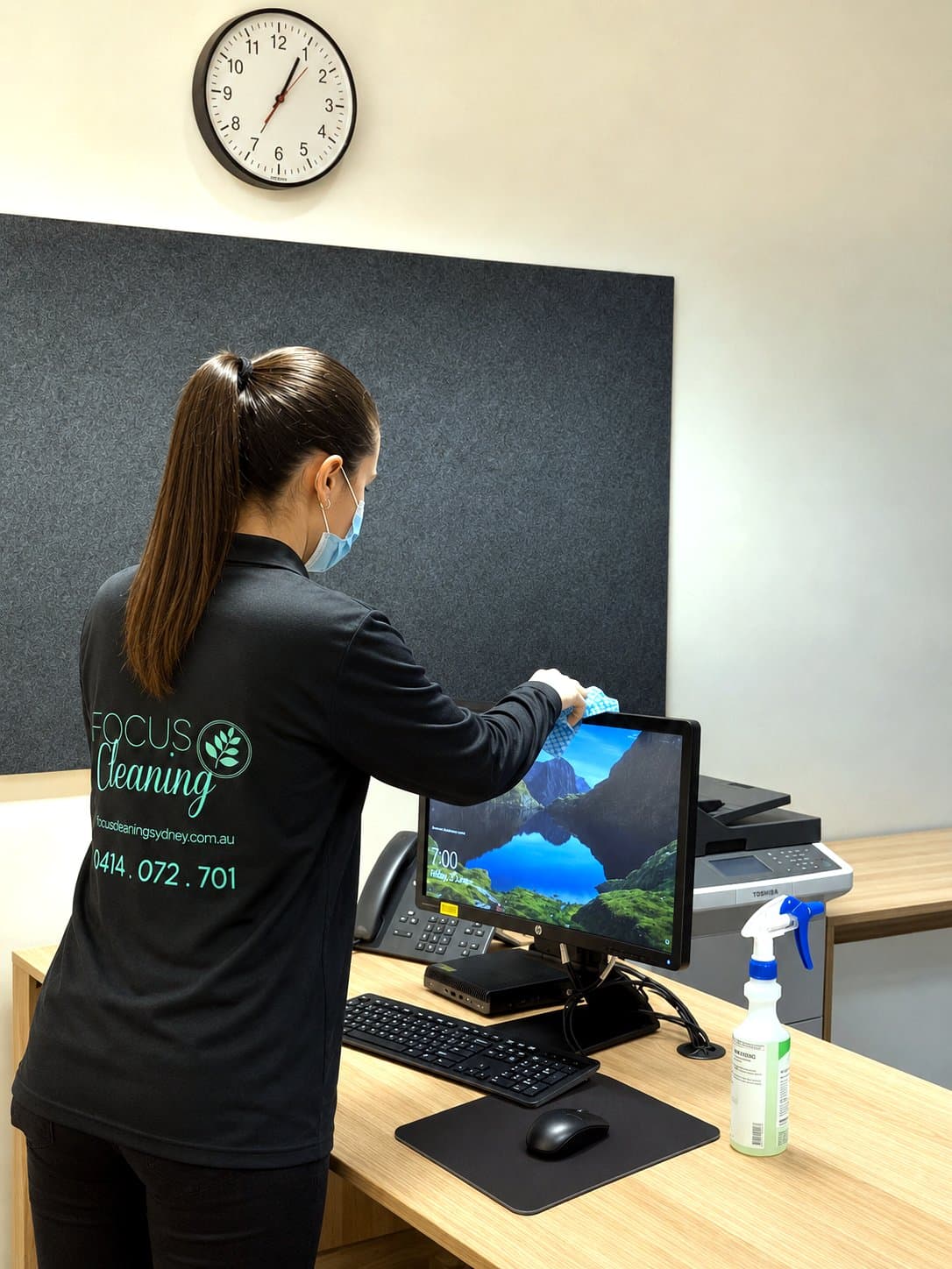 Focus cleaner wiping down office workstations